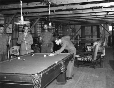 Soldiers playing pool during World War II